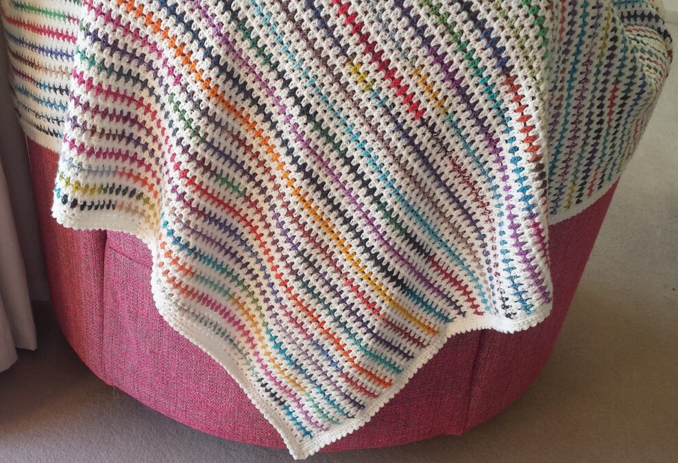 Diamond stitch blanket draped over chair