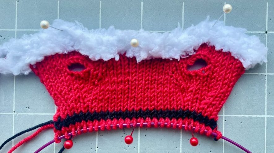 Pinned knitted piece after row 20 after the belt and just before starting the skirt increases
