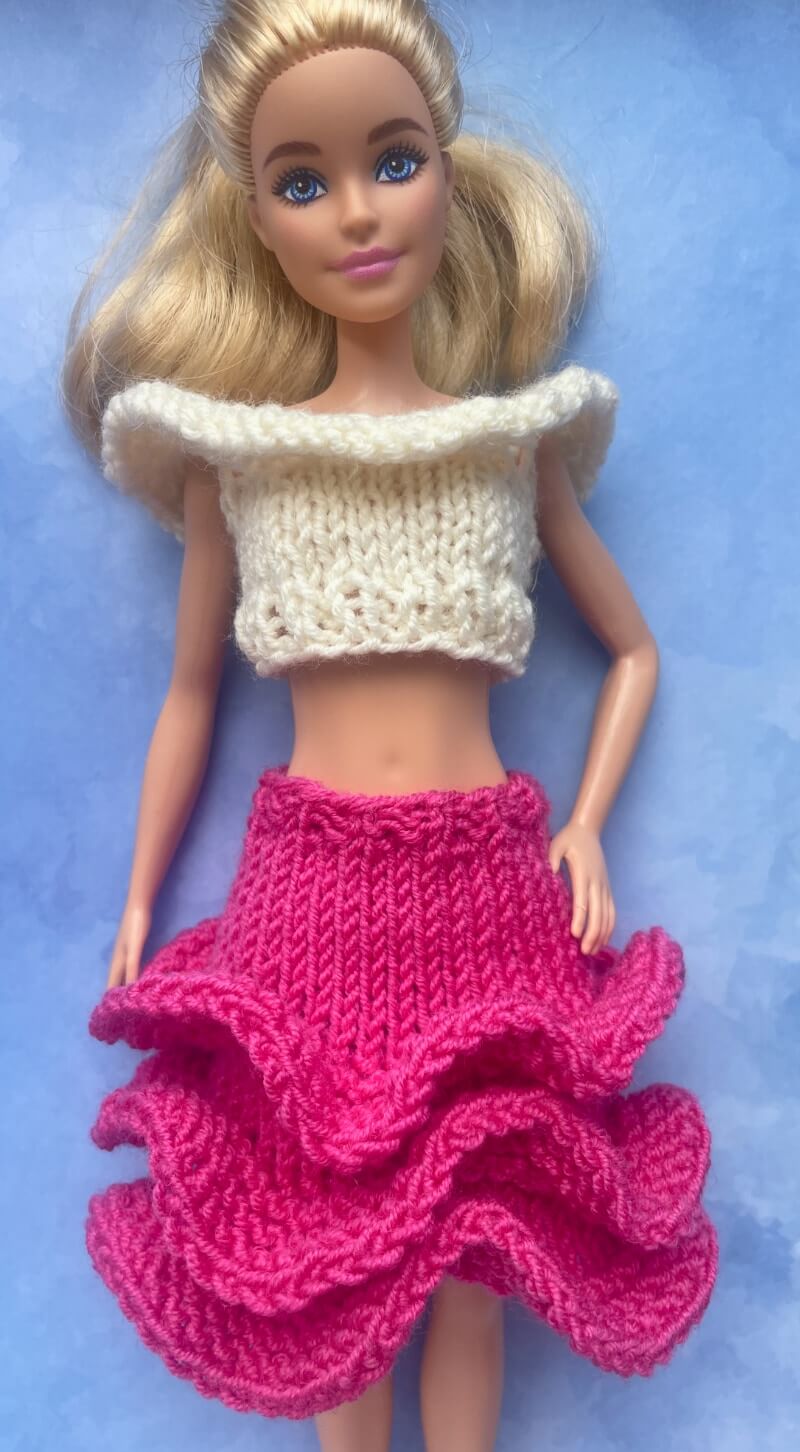 Barbie doll wearing finished ruffle crop top and 3 ruffle skirt