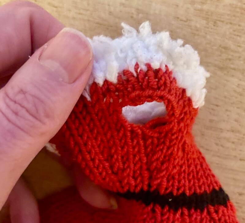 Close up of armhole made by casting off stitches in round 7 and then casting on 2 more in round 8