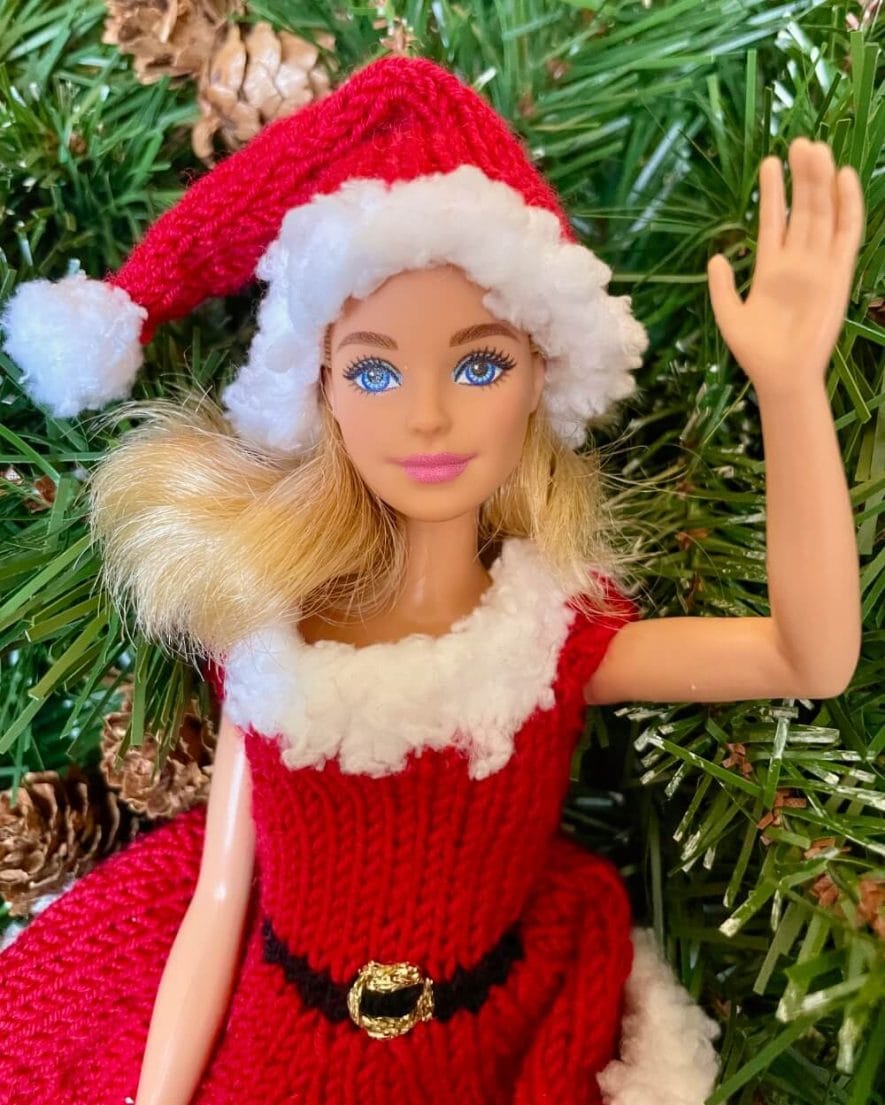 barbie doll waving wearing knitted Santa dress and hat