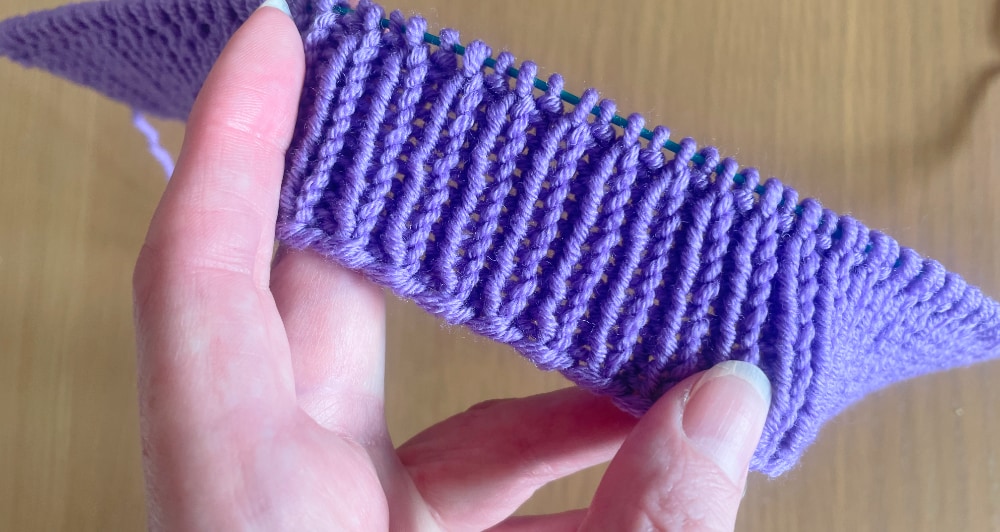 Adult DK beanie after knitting 11 rounds of rib