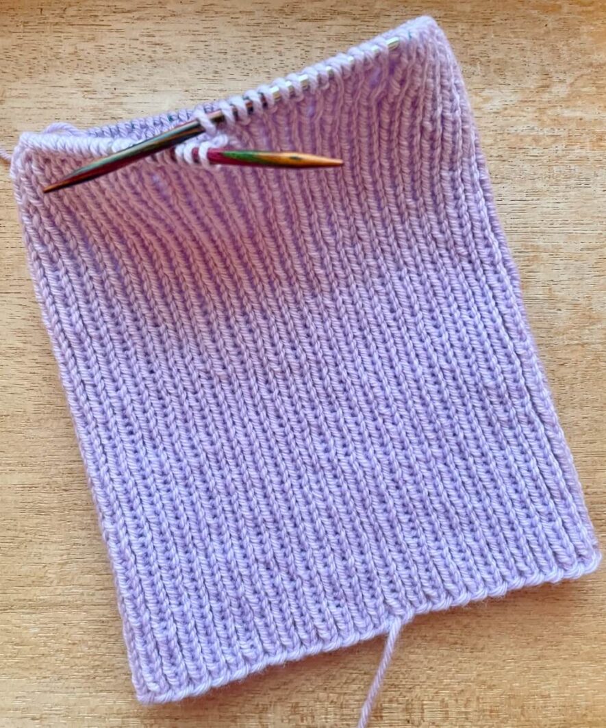 Knit a simple tube of 1x1 rib stitch until you reach the crown - 8.25 inches of rib shown here for child size with turn-up (option b)