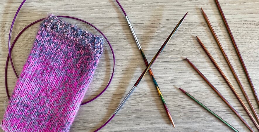 Circular and double pointed knitting needles with handknit phone cover