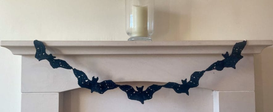 Halloween mantel garland made by joining 5 crochet bats together
