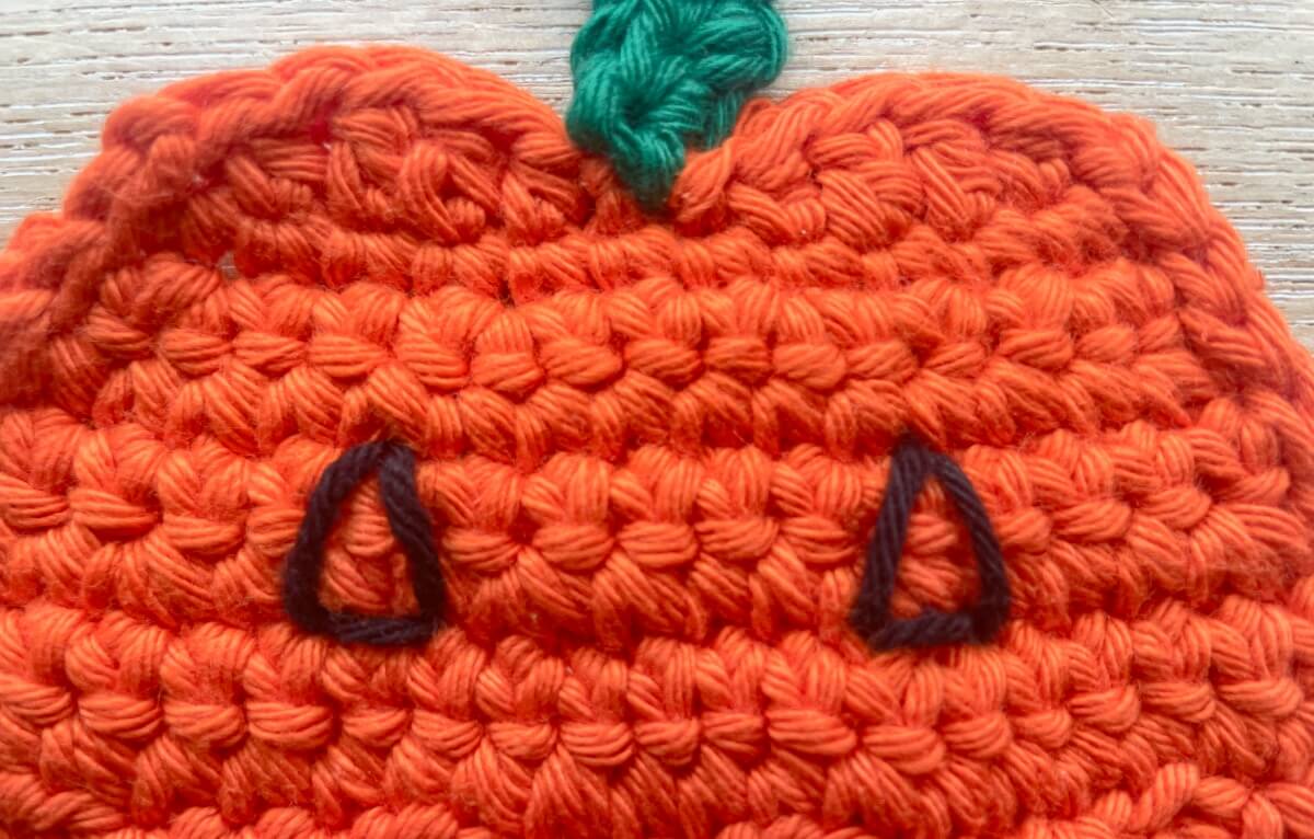 Embroider a triangle for each eye & then fill these in with vertical and diagonal stitches