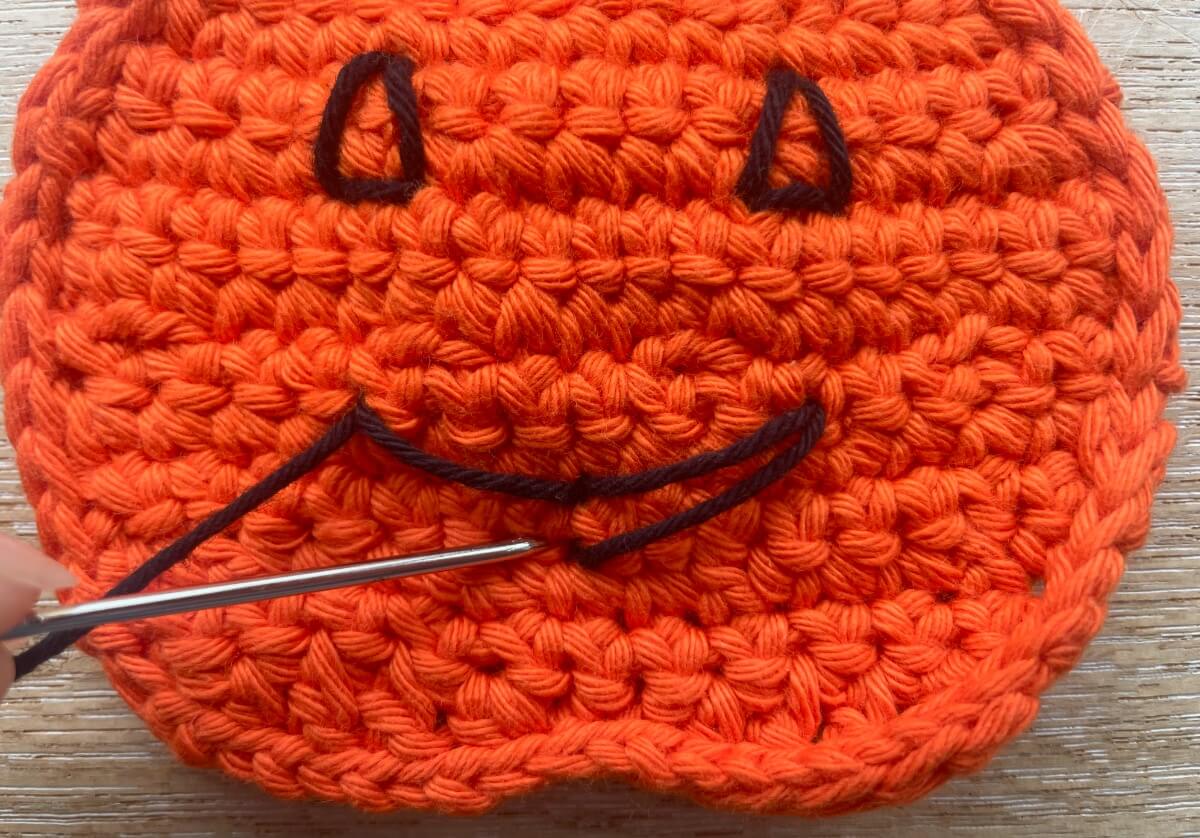 Embroider the mouth outline by making 4 long stitches