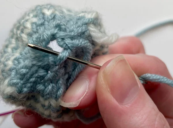 Close the base of the egg by gathering the cast on stitches
