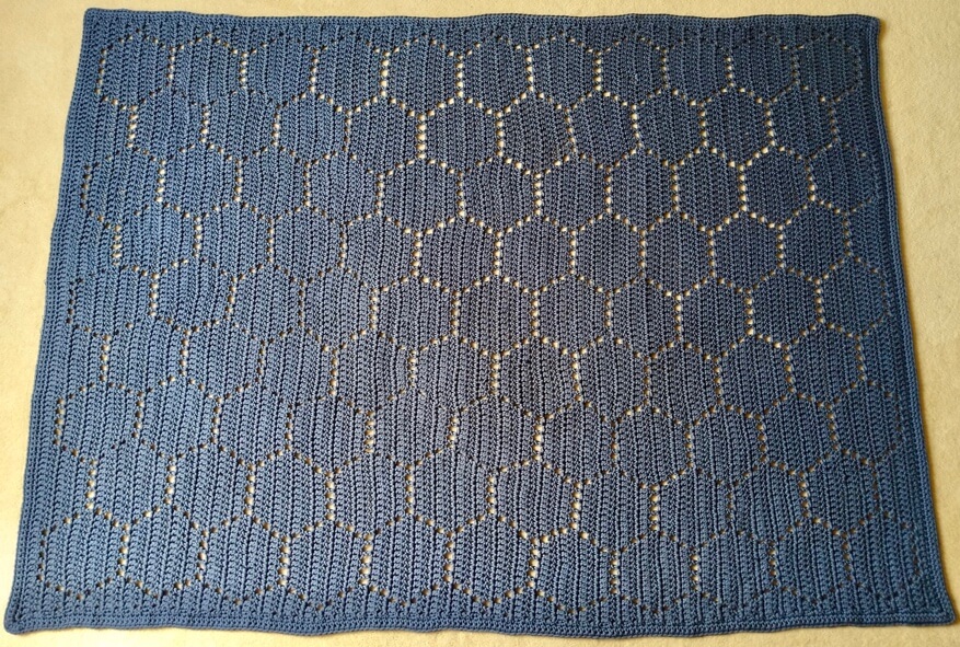 Large crochet honeycomb blanket made with chunky acrylic yarn