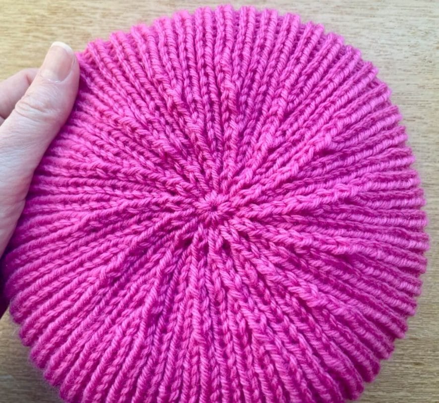 Crown decreases make a swirl shape on top of ribbed hat