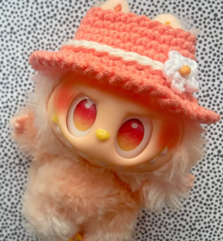Labubu wearing crochet bucket hat with flower embellishment