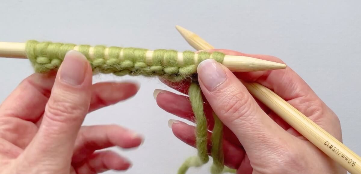 If you use a long tail cast on with straight needles, row 1 is the wrong side of your knitting