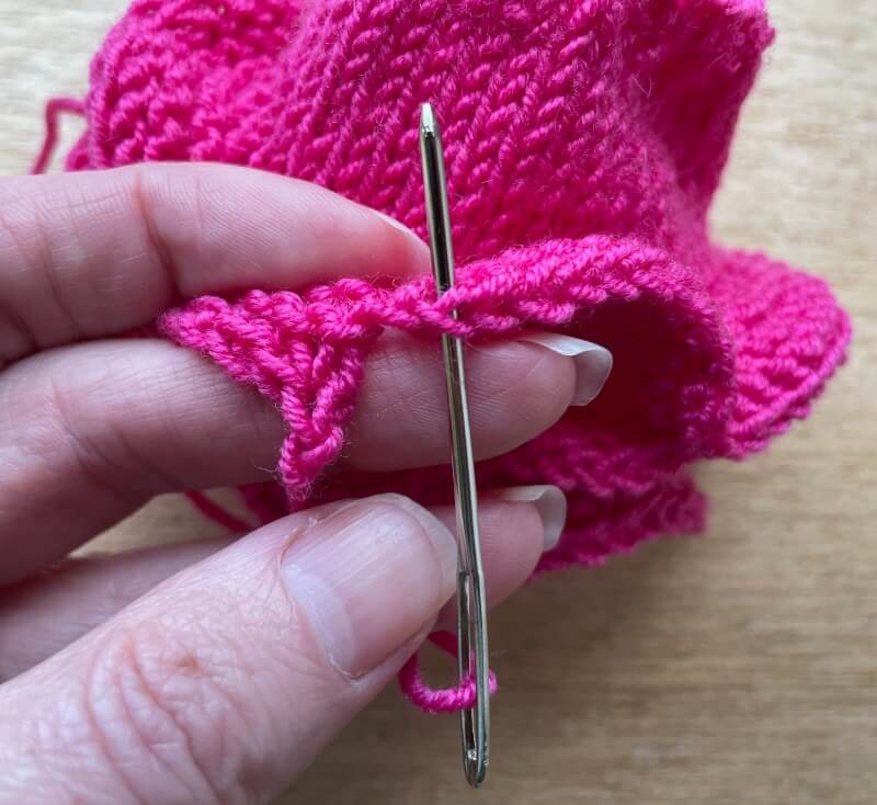Fix the height difference by weaving the end through the first bind off "v shape" chain on the right