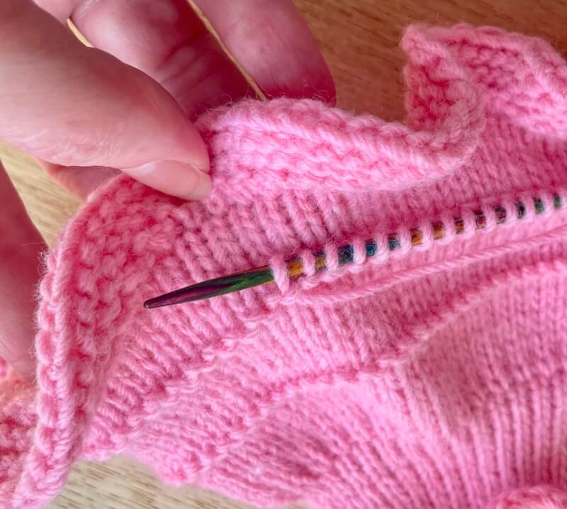 put your needle in through each purl stitch u shape to pick up and knit a stitch