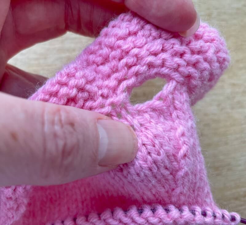 Close up of armhole made by binding off stitches on row 9 and casting on more on row 10