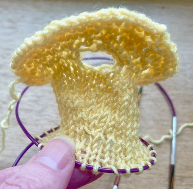 Finished top of dress from side showing arm hole under neck ruffle
