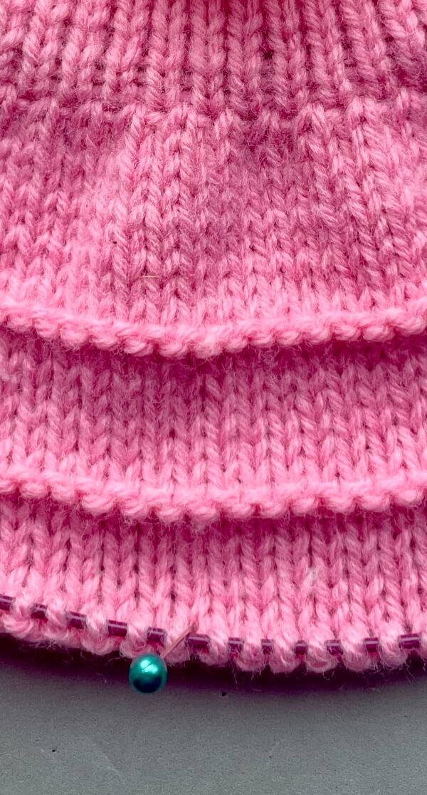 The single purl rounds are where the ruffles will be added at the end by picking up stitches in the purl bumps