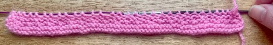 Knitting after row 8 with the garter stitch neck ruffle complete