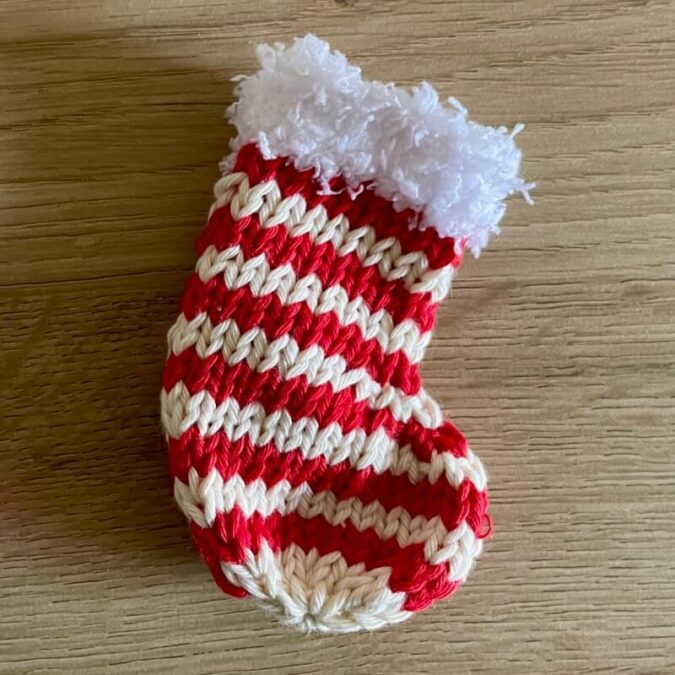 Red & white striped knitted stocking with fluffy white cuff