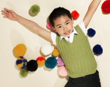 Child wearing free vest knitting pattern