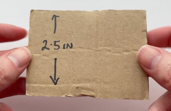 A 2.5 inch tall piece of cardboard makes a 2 inch tassel