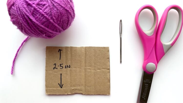 You need yarn, cardboard, a needle and scissors to make a tassel
