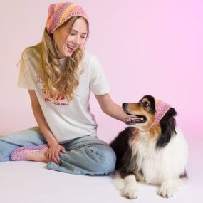 Girl and dog wearing cutie kerchief knitting pattern
